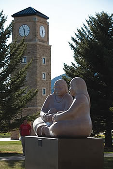 statues in front of clocktower