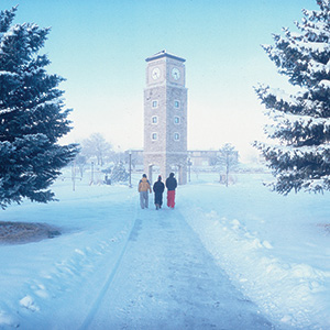 Students walking toward the clocktower in the snow.