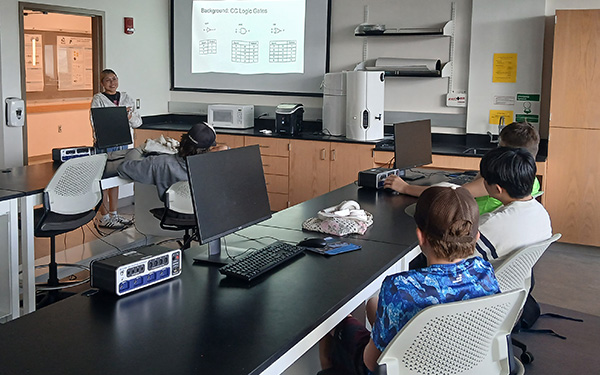 Female student presenting to a small group of students