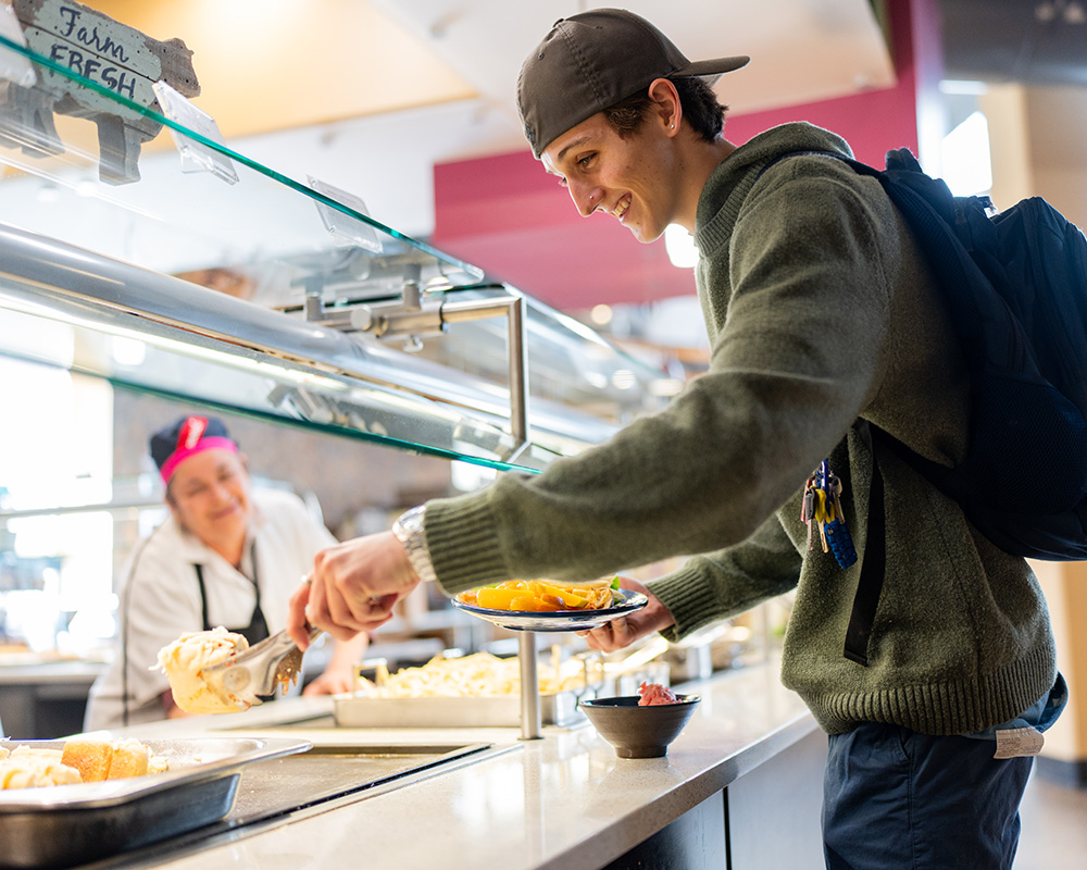 A student making a plate at San Juan Dining Hall in the Student Union.