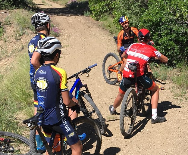 Mountain bike riders chat with Payson McElveen on a ride in Durango